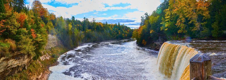 Best Places To Camp In Michigan 2 Scenic waterfall surrounded by forest at Tahquamenon Falls State Park camping site
