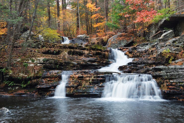Best Places To Camp In Maryland 7 Tent near waterfall and forest trail at Cunningham Falls — waterfall-side camping in Maryland