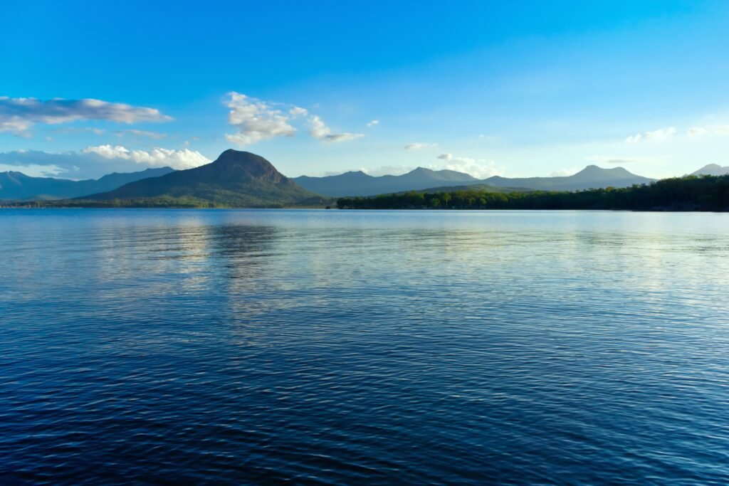 Tent along Cascade Lake with calm water and tree-lined horizon.